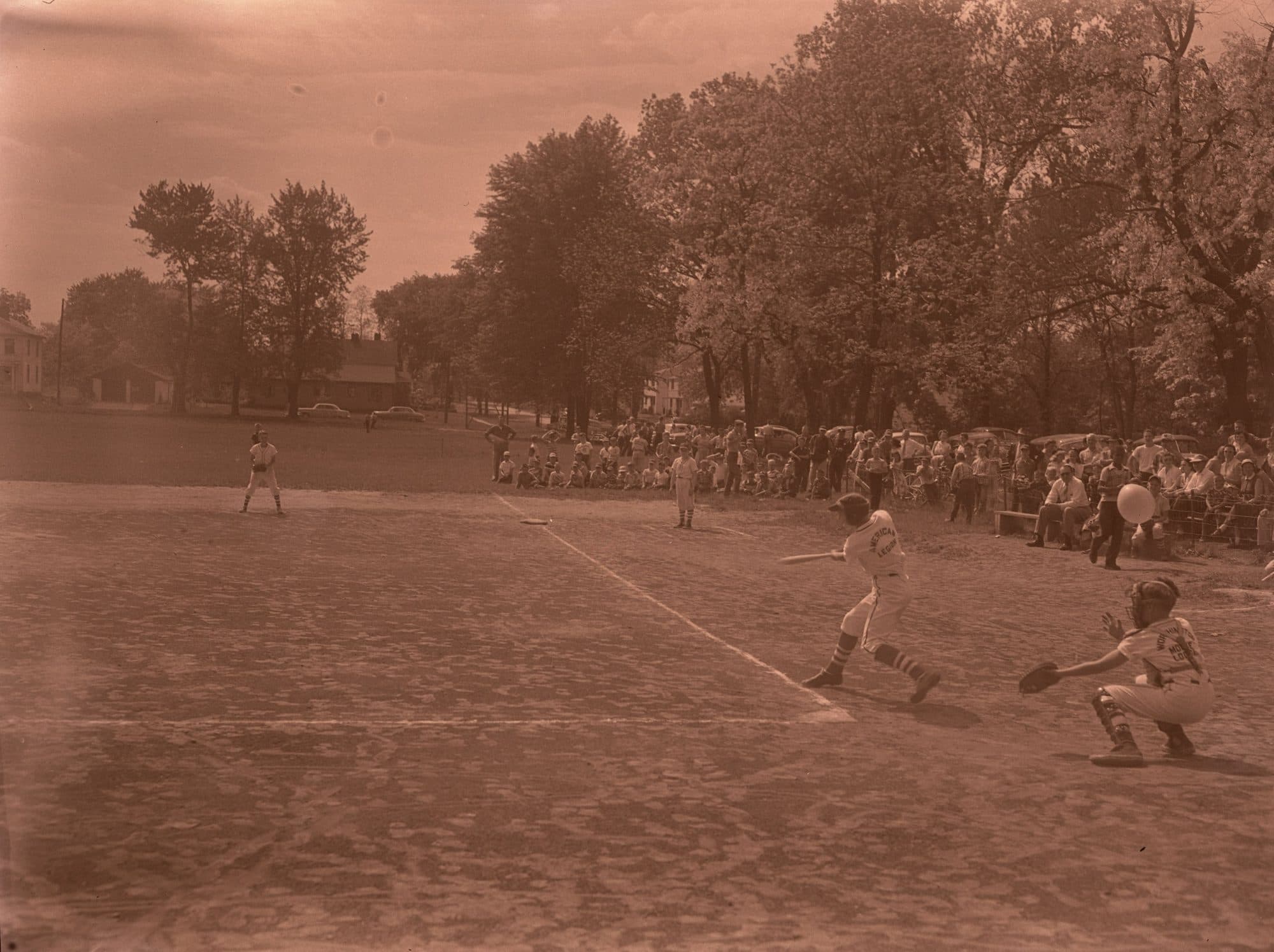 The whole of that negative: a boys' ball game in Ohio around 1955. It is not the Abington team (no free photograph of them exists); it is the kind of afternoon the first Leo club was formed out of.